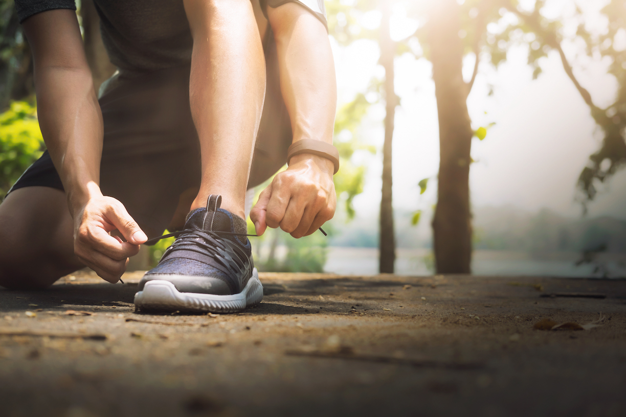 Runner tying running shoes before a workout